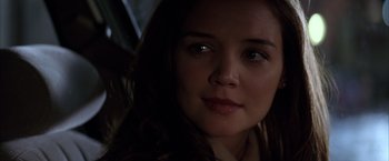 Movie still from “Batman Begins” (2005), directed by Christopher Nolan – A woman's face in the dark; Close Up shot, Over the shoulder angle