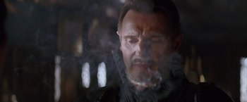 Movie still from “Batman Begins” (2005), directed by Christopher Nolan – A person smoking a cigarette; Close Up shot, Low angle