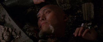 Movie still from “Batman Begins” (2005), directed by Christopher Nolan – A bald man is shaving his face with a razor; Close Up shot, Overhead angle