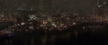 Movie still from “Batman Begins” (2005), directed by Christopher Nolan – A city lit up at night by the lights of street lamps; Extreme Wide shot, High angle