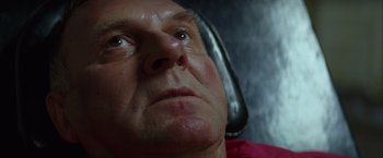 Movie still from “Batman Begins” (2005), directed by Christopher Nolan – An older man is looking into the distance; Close Up shot, Low angle