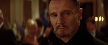 Movie still from “Batman Begins” (2005), directed by Christopher Nolan – Liam neeson looking at the camera; Close Up shot, Over the shoulder angle