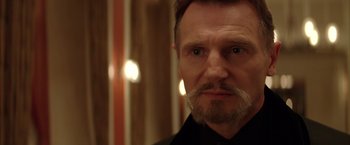 Movie still from “Batman Begins” (2005), directed by Christopher Nolan – A person with a mustache; Close Up shot, Low angle