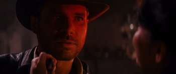 Movie still from “Raiders of the Lost Ark” (1981), directed by Steven Spielberg – A person wearing a hat; Close Up shot, Over the shoulder angle