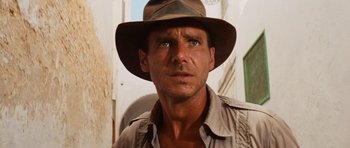 Movie still from “Raiders of the Lost Ark” (1981), directed by Steven Spielberg – A person wearing a hat; Close Up shot, Low angle