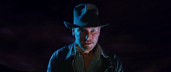 Movie still from “Raiders of the Lost Ark” (1981), directed by Steven Spielberg – A person wearing a hat; Close Up shot, Low angle