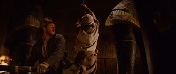 Movie still from “Raiders of the Lost Ark” (1981), directed by Steven Spielberg – A man hanging from the ceiling of an egyptian temple; Medium shot, Low angle