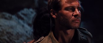 Movie still from “Raiders of the Lost Ark” (1981), directed by Steven Spielberg – A person with a beard; Close Up shot, Over the shoulder angle