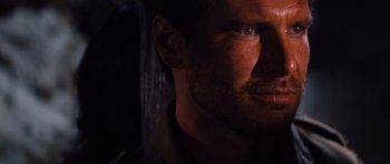 Movie still from “Raiders of the Lost Ark” (1981), directed by Steven Spielberg – A man with a beard looking up; Close Up shot, Over the shoulder angle