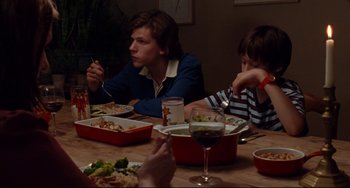 Movie still from “The Squid and the Whale” (2005), directed by Noah Baumbach – A group of people sitting at a table with food; Medium shot, Over the shoulder angle