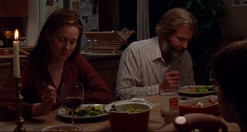 Movie still from “The Squid and the Whale” (2005), directed by Noah Baumbach – A man and a woman sitting at a dinner table; Medium shot, High angle