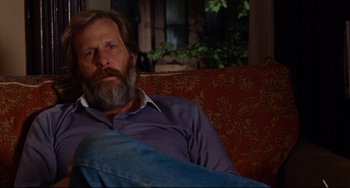 Movie still from “The Squid and the Whale” (2005), directed by Noah Baumbach – A man sitting on top of a red couch in a living room; Close Up shot, Over the shoulder angle