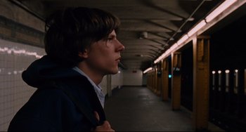 Movie still from “The Squid and the Whale” (2005), directed by Noah Baumbach – A young man standing in a hallway looking to his left; Close Up shot, Over the shoulder angle