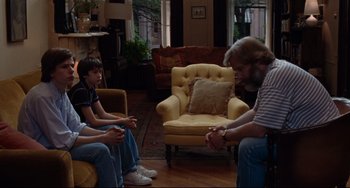 Movie still from “The Squid and the Whale” (2005), directed by Noah Baumbach – A group of people sitting in a living room together; Medium shot, Over the shoulder angle