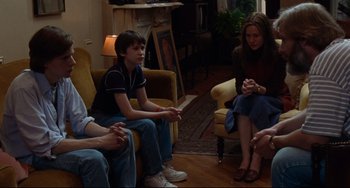 Movie still from “The Squid and the Whale” (2005), directed by Noah Baumbach – A group of people sitting in a living room talking; Medium shot, Over the shoulder angle