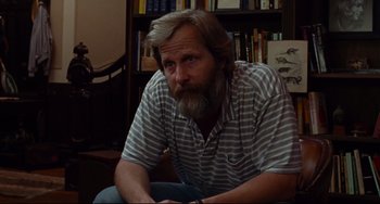 Movie still from “The Squid and the Whale” (2005), directed by Noah Baumbach – A man sitting in a chair in front of a book shelf; Medium shot, Over the shoulder angle