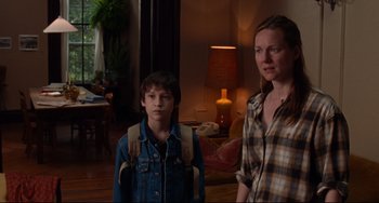 Movie still from “The Squid and the Whale” (2005), directed by Noah Baumbach – A woman and a young boy standing in a living room; Medium shot, Over the shoulder angle