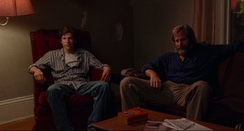 Movie still from “The Squid and the Whale” (2005), directed by Noah Baumbach – Two men sitting in a living room next to each other; Medium shot, Low angle