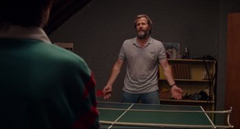 Movie still from “The Squid and the Whale” (2005), directed by Noah Baumbach – A man standing in front of a ping pong table; Medium shot, Over the shoulder angle