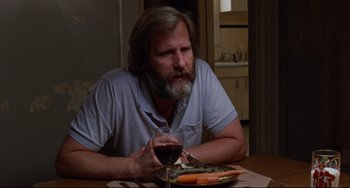 Movie still from “The Squid and the Whale” (2005), directed by Noah Baumbach – A man sitting at a table with a glass of red wine; Medium shot, Over the shoulder angle