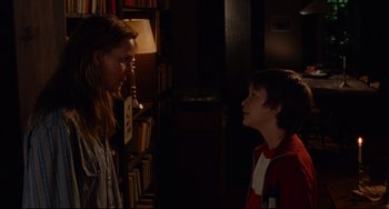 Movie still from “The Squid and the Whale” (2005), directed by Noah Baumbach – A woman and a young boy standing next to each other in a room; Medium shot, Over the shoulder angle