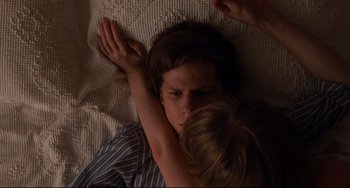 Movie still from “The Squid and the Whale” (2005), directed by Noah Baumbach – A boy and a girl laying in a bed together; Close Up shot, Overhead angle
