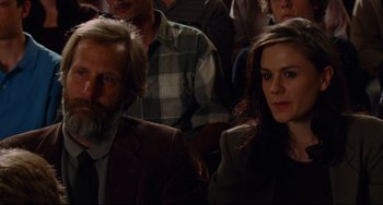 Movie still from “The Squid and the Whale” (2005), directed by Noah Baumbach – A man and a woman sitting next to each other in a crowd; Close Up shot, Over the shoulder angle