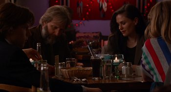 Movie still from “The Squid and the Whale” (2005), directed by Noah Baumbach – A man and a woman sitting at a dinner table; Medium shot, Over the shoulder angle