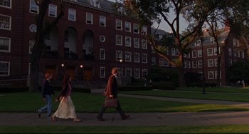 Movie still from “The Squid and the Whale” (2005), directed by Noah Baumbach – A man and a woman are walking on a sidewalk; Extreme Wide shot, High angle
