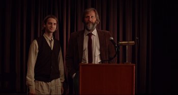 Movie still from “The Squid and the Whale” (2005), directed by Noah Baumbach – A man standing next to a man standing next to a microphone; Medium shot, Low angle
