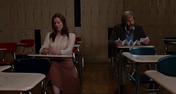Movie still from “The Squid and the Whale” (2005), directed by Noah Baumbach – A woman and a man sitting at a desk in front of each other; Medium shot, Low angle
