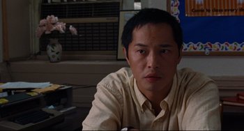 Movie still from “The Squid and the Whale” (2005), directed by Noah Baumbach – A person sitting at a table; Close Up shot, Low angle