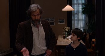 Movie still from “The Squid and the Whale” (2005), directed by Noah Baumbach – A man standing next to a young boy in a room; Medium shot, Over the shoulder angle