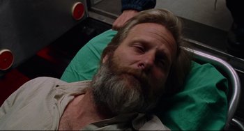 Movie still from “The Squid and the Whale” (2005), directed by Noah Baumbach – A man with a beard laying on the ground; Close Up shot, Overhead angle