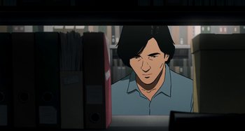 Movie still from “The Summit of the Gods” (2021), directed by Patrick Imbert – A man with long hair is looking out of a window; Medium shot, Over the shoulder angle