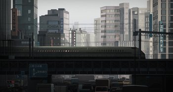 Movie still from “The Summit of the Gods” (2021), directed by Patrick Imbert – A train traveling down the tracks in a city; Extreme Wide shot, Low angle