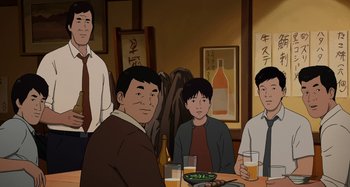 Movie still from “The Summit of the Gods” (2021), directed by Patrick Imbert – A group of men sitting at a table with a plate of food; Medium shot, High angle