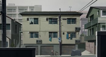 Movie still from “The Summit of the Gods” (2021), directed by Patrick Imbert – A bicycle parked on the side of a building; Extreme Wide shot, Low angle