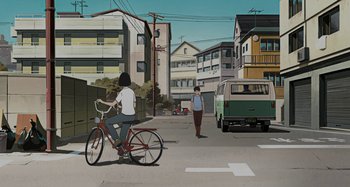 Movie still from “The Summit of the Gods” (2021), directed by Patrick Imbert – A woman riding a bike down a street; Extreme Wide shot, High angle