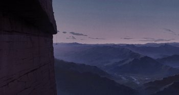 Movie still from “The Summit of the Gods” (2021), directed by Patrick Imbert – A man hanging from a cliff while looking out over a valley at dusk; Extreme Wide shot, Low angle