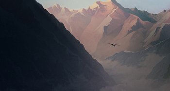 Movie still from “The Summit of the Gods” (2021), directed by Patrick Imbert – An airplane is flying over a mountain range at sunset; Extreme Wide shot, Overhead angle