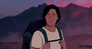 Movie still from “The Summit of the Gods” (2021), directed by Patrick Imbert – A man with a backpack standing in front of a mountain range; Medium shot, Low angle