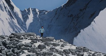 Movie still from “The Summit of the Gods” (2021), directed by Patrick Imbert – A person standing on top of a snow covered slope; Extreme Wide shot, Low angle