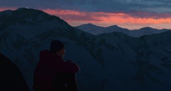 Movie still from “The Summit of the Gods” (2021), directed by Patrick Imbert – A man sitting on top of a mountain looking at the sky; Extreme Wide shot, Low angle