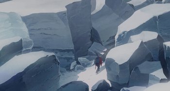 Movie still from “The Summit of the Gods” (2021), directed by Patrick Imbert – A person is walking through a rocky area; Extreme Wide shot, Overhead angle