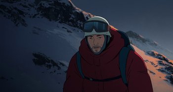 Movie still from “The Summit of the Gods” (2021), directed by Patrick Imbert – A man in a red jacket is standing in the snow; Close Up shot, Low angle