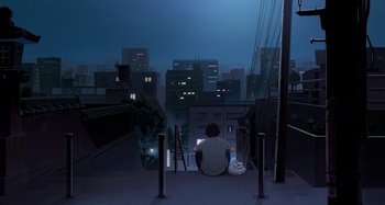 Movie still from “The Summit of the Gods” (2021), directed by Patrick Imbert – A man sitting on a ledge looking out over a city at night; Extreme Wide shot, Low angle
