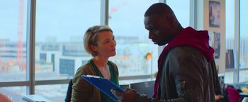 Movie still from “The Takedown” (2022), directed by Louis Leterrier – A man and a woman are looking at each other; Medium shot, Over the shoulder angle