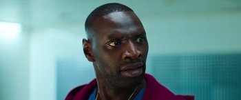 Movie still from “The Takedown” (2022), directed by Louis Leterrier – A person wearing a jacket; Close Up shot, Low angle