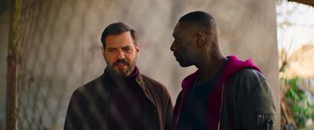 Movie still from “The Takedown” (2022), directed by Louis Leterrier – Medium shot, Over the shoulder angle